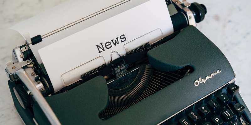 a close up of a typewriter with the word crisis typed on a sheet of paper