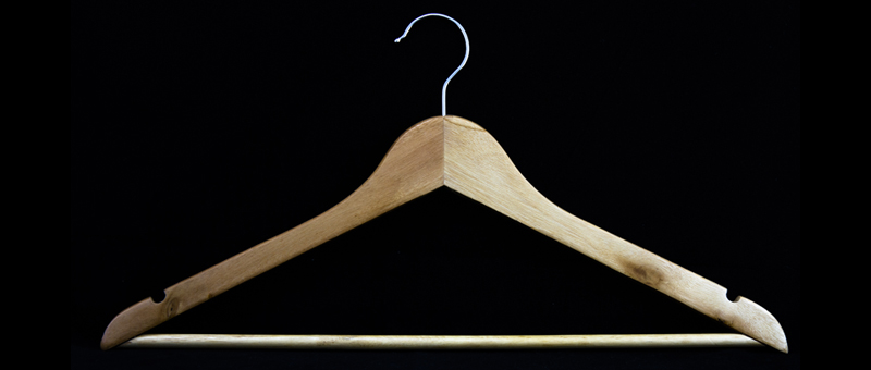 a coat hanger on a black background