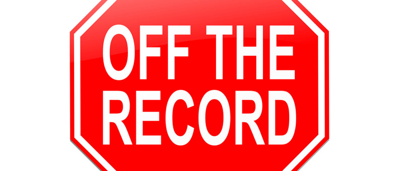 red octagonal sign with the words off the record