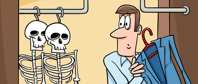 cartoon of two skeletons hanging in a closet where a man is hanging his jacket