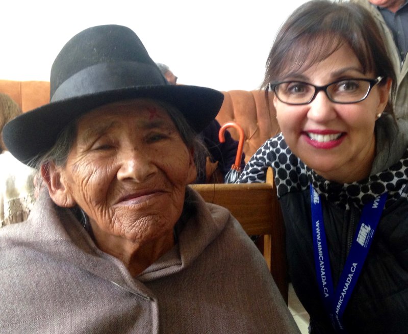 an old woman and young woman smiling at the camera