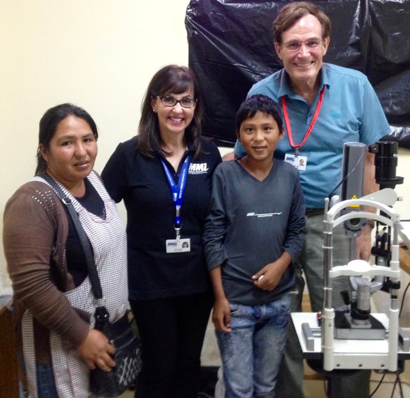 four people standing in front of eye-testing equipment