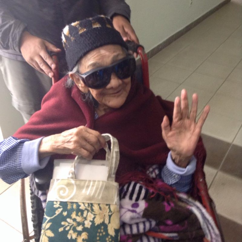 an elderly woman being pushed in a wheelchair