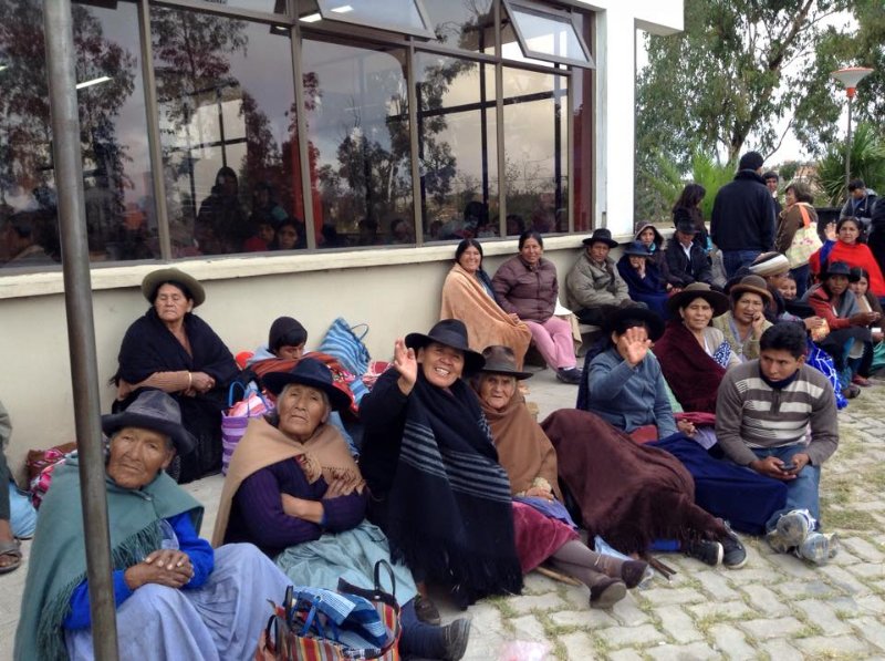 a large group of people sitting on the ground outside